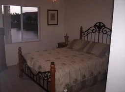 Master bedroom with queen size bed, over looking lake with fountain