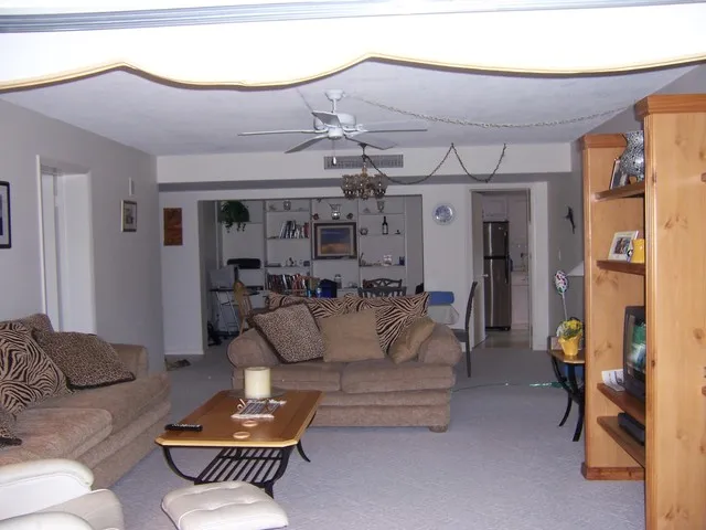 Living room with entertainment center, and formal dining area adjacent rear