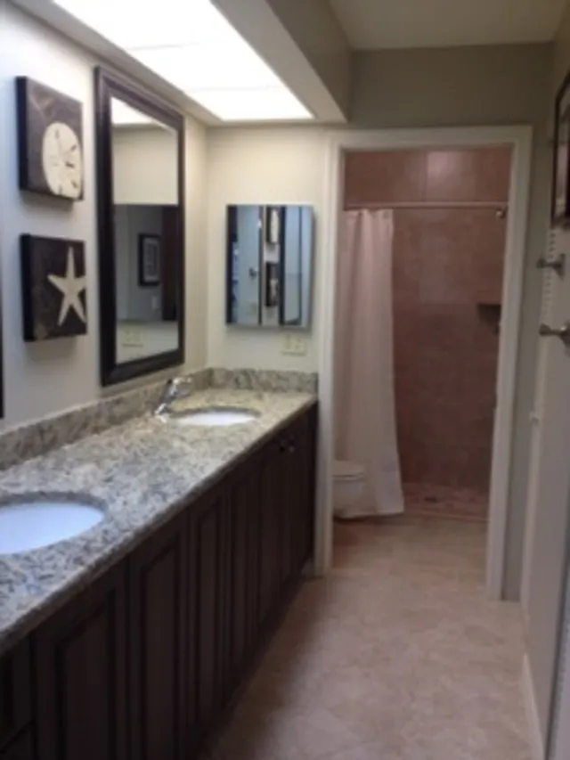 Master Bath with double sink, private toilet and large shower.