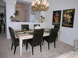 Diningroom with elegant chandelier and furniture with antique finish.