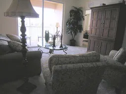 Livingroom has sliders to balcony which has beautiful outdoor furniture.