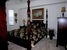 Master bedroom with Ralph Lauren bedding, armoire with tv and bay window.