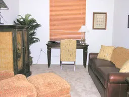Golf themed den with leather sleeper sofa and hand painted armoire with tv.