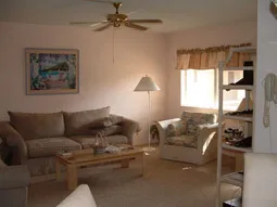 Living room with courtyard-facing windows.