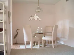 Dining area for 4 with kitchen to the left.