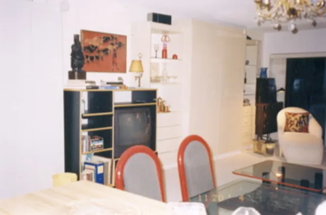 A double and a queen Murphy bed on either side of entertainment console.