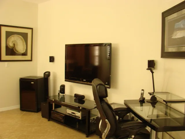 The sitting room features a flat screen tv and surround sound system