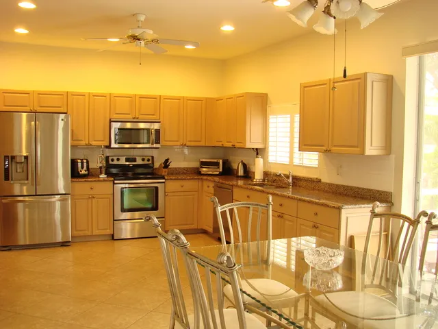 Kitchen has granite, stainless steel appliances and includes everything needed to dine pool side