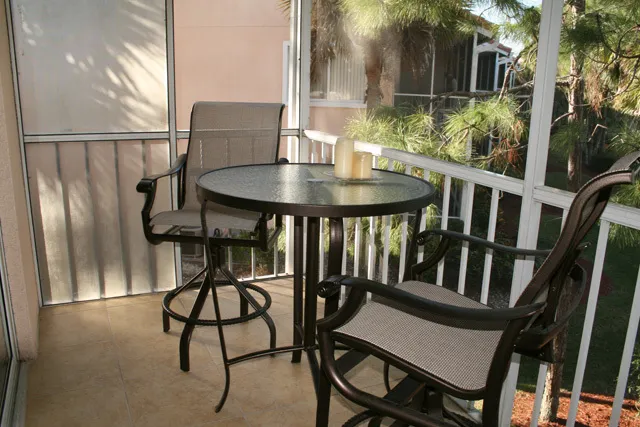 Table and chairs on the lanai, on the family room side. 