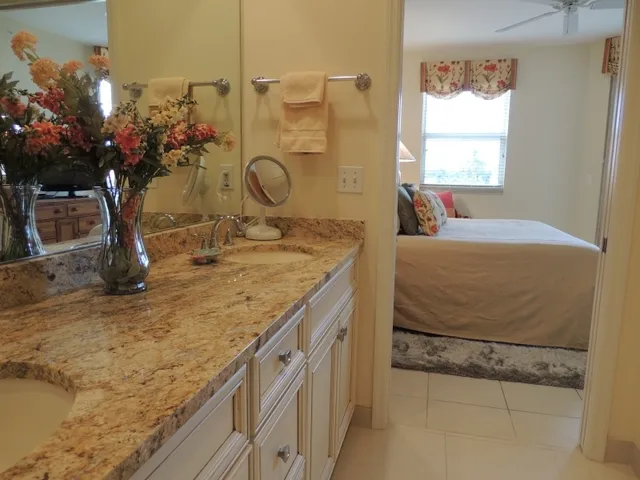Renovated master bathroom with dual sinks, walk in shower & a walk in closet
