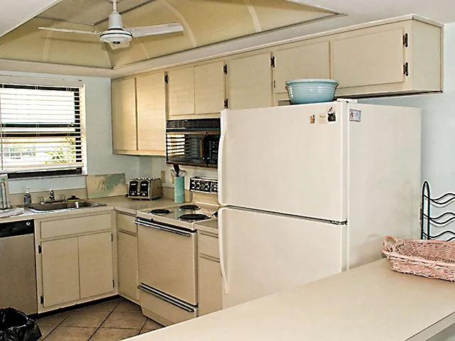 Fully stocked kitchen with ceiling fan, microwave & dishwasher.