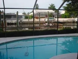 Pool deck/ lanai with waterfront canal view