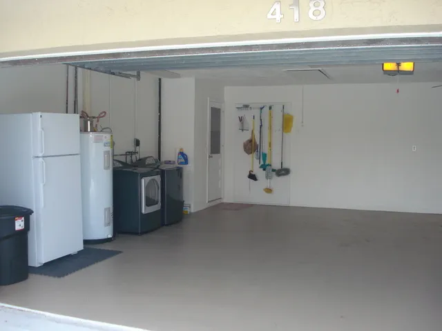 extra fridge with washer and dryer in clean garage