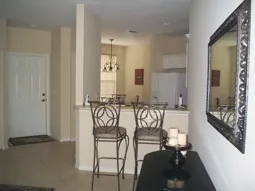 From Family room looking into eat in kitchen beyond bar and stools.
