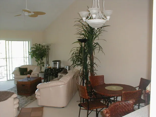 Oversized, comfy furniture in living room, overlooks lanai & woods