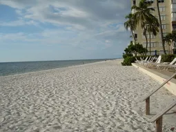 expansive beach and beach chairs in front of building