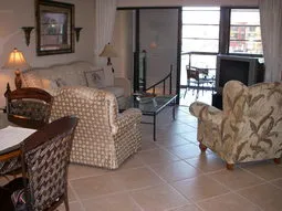 living room with lanai and spiral staircase down to day room.