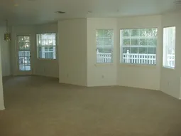 Living room with view of formal dinning room and back deck.