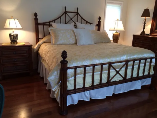 Master bedroom features a King size Tommy Bahama style bed and new King size mattress.  Beautiful hardwood floors add warm touch to room.