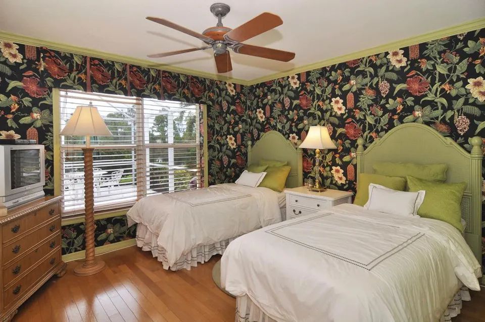 The Third bedroom truly captures what tropical means in the wallpaper, valances to match and twin rattan/ wicker beds.