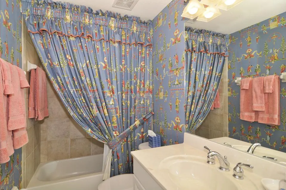 The Guest bathroom features a custom made shower curtain to match the Chinoiserie wallpaper.