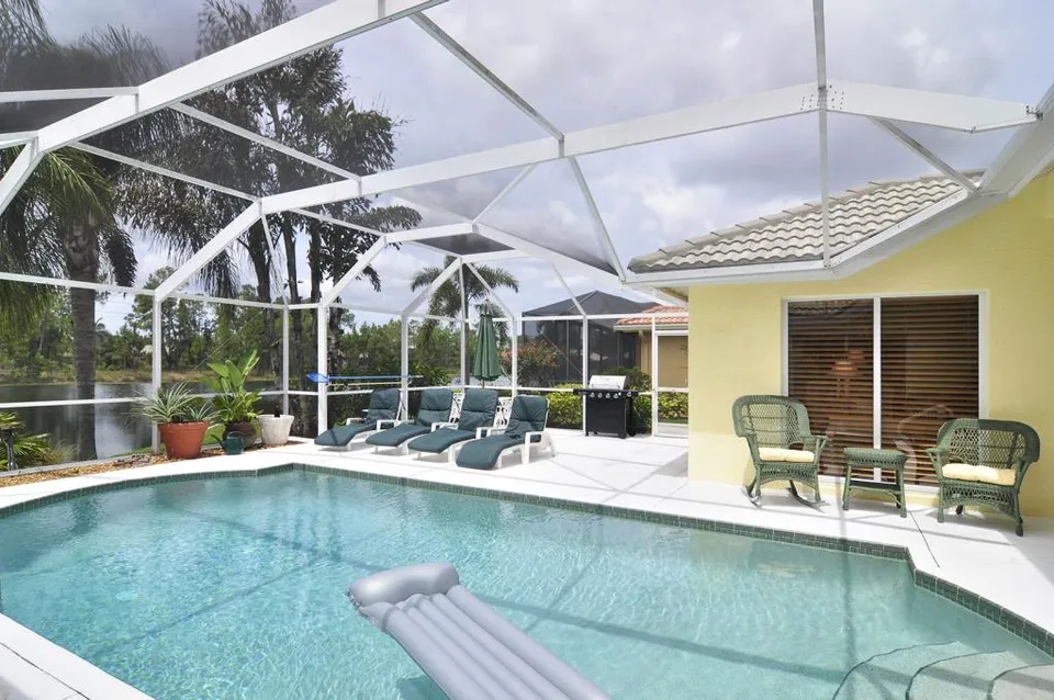 We built our house so that the pool faces a large lake and preserve so it is quite private. It has much desired Southern exposure so that there is always sunshine over the pool.  There is a large seating area for the sun worshippers that has four chaise lounges. 
