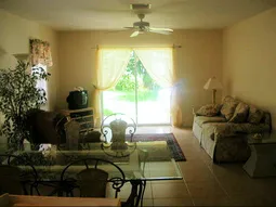 Large family room off kitchen leads out to sceened in lanai and backyard