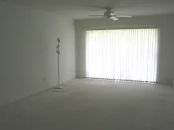 Bright, neutral large living room with sliding glass doors to lanai,lakevie