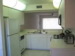 Light, clean neutral kitchen with all appliances. Ceramic tile.