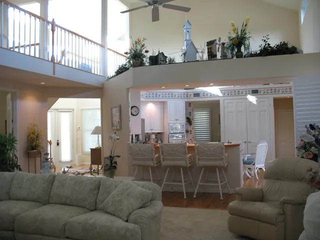 Bright and spacious. View of kitchen & balcony from living room. 
