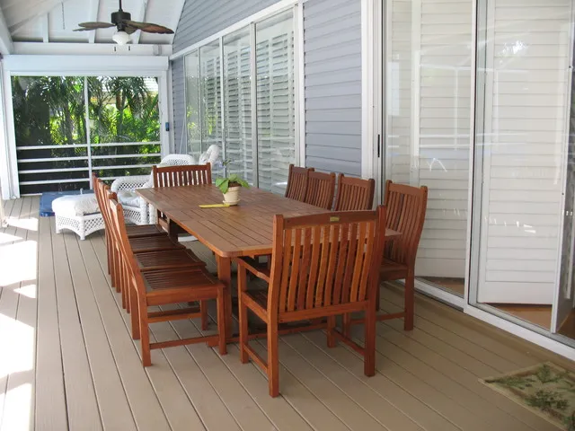 Teak table for outdoor dining on lanai. Seating for 10 