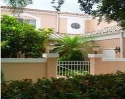 Exterior of luxury villa with private gated courtyard.