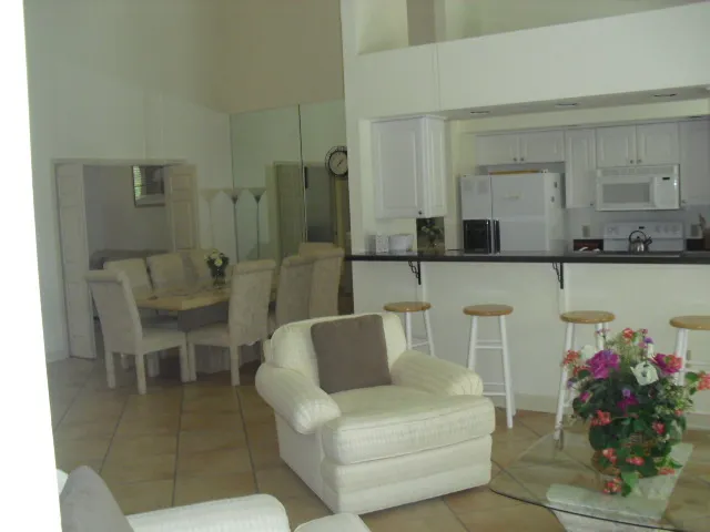 Standing in formal living area looking towards kitchen and dining area.