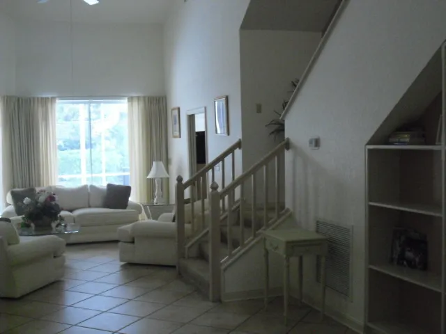 Standing near front door looking into formal living area and pool area.