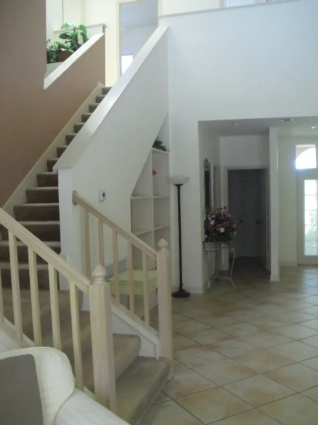 Standing in formal living area looking towards front door and stairs