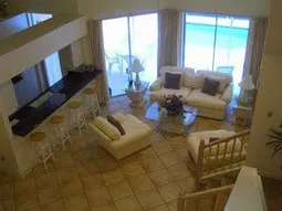 Great room with cathedral ceilings overlooking private pool area.