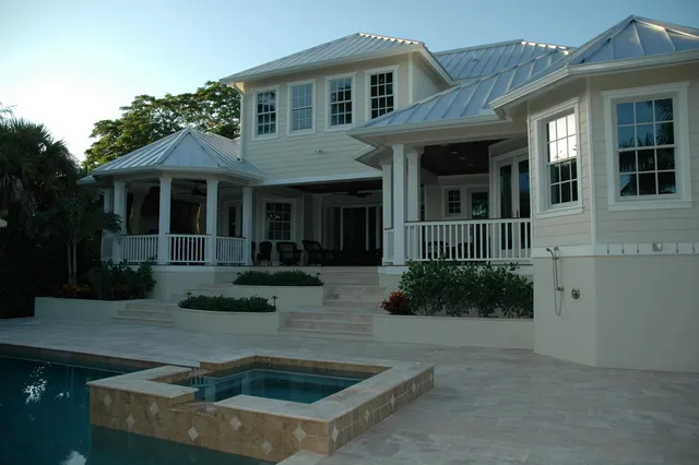 View of the back of the home, with hot tub and pool.