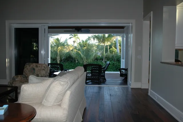 View through the great room, out the four sliding doors to lanai.