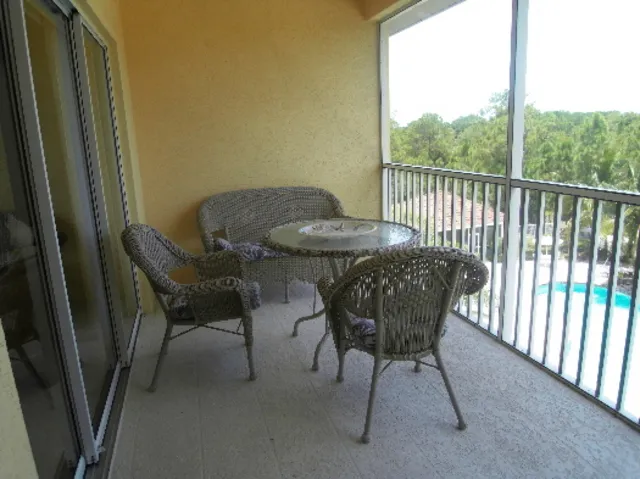 Balcony overlooking pool and picnic area