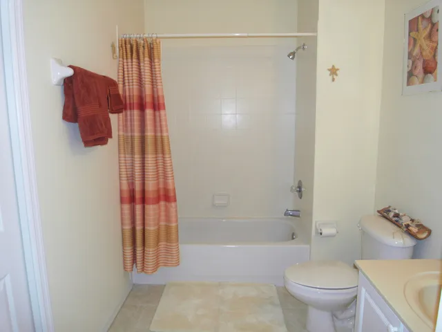 Guest Bathroom with bath with shower over.