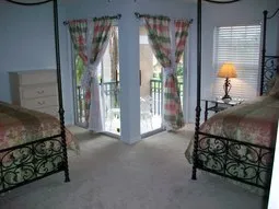 Second master features 2 queen beds, attached bath & balcony with lake view