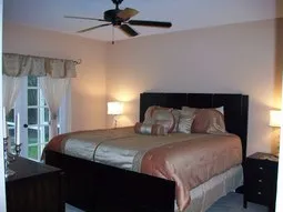 1st floor Master suite has king bed, french doors to pool & walk-in closet