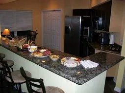 Open kitchen with granite counters, deep sink & stainless steel appliances