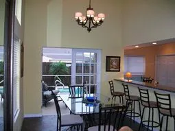 Lovely dining area seats 8 and has french doors leading to pool/lanai