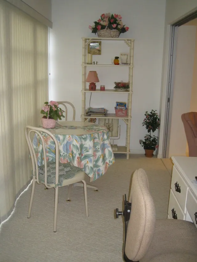 Lanai has a cafe table & chairs overlooking the beautiful grounds