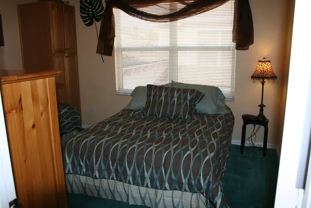 Tropical guest room with full bed & twin day bed.