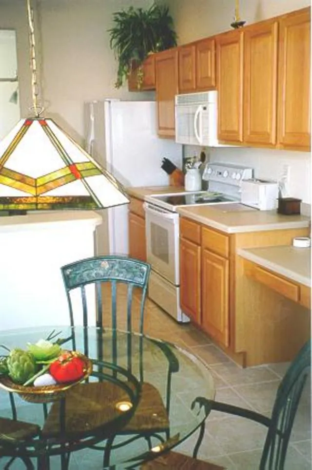 Kitchen with corian and hardwood cabinetry
