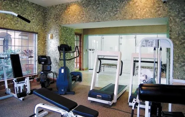 Workout in the Fitness Center. Recquetball court located behind the glass.