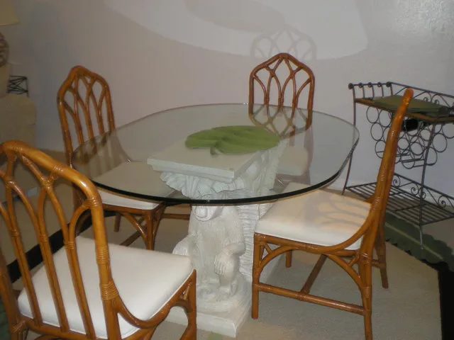 Large dining table with seating for four and room for additional seats.