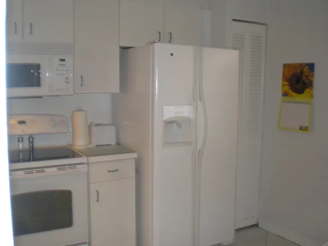 Kitchen with full amenities including new dishwasher, range and microwave.